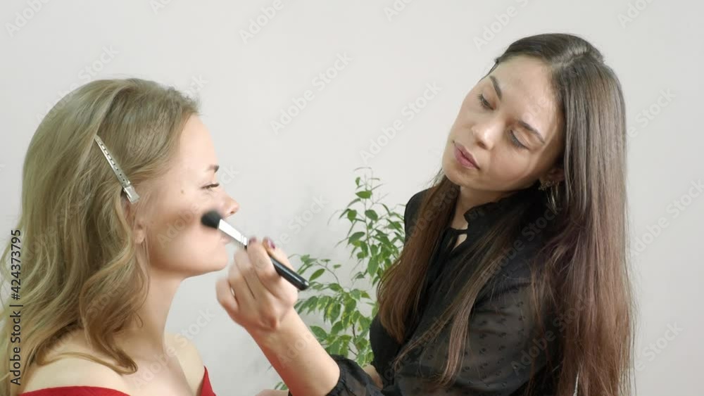 beautiful blonde in a beauty salon, does makeup beautiful blonde in a beauty salon, does makeup