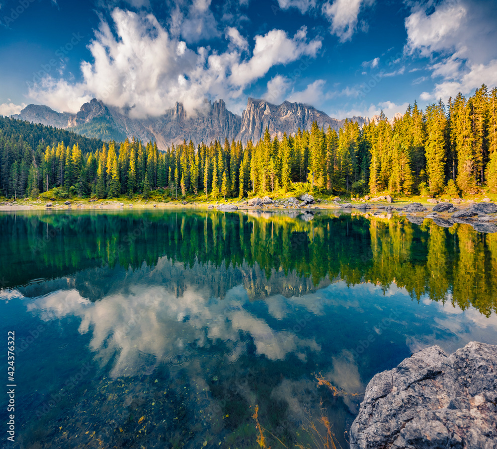 Beautiful summer scenery. Stunning summer view of Carezza (Karersee) lake. Exciting morning scene of Dolomiti Alps, Province of Bolzano, South Tyrol, Italy, Europe. Traveling concept background..