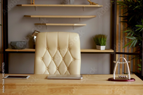 A  cozy workplace in a home office with a white leather office chair