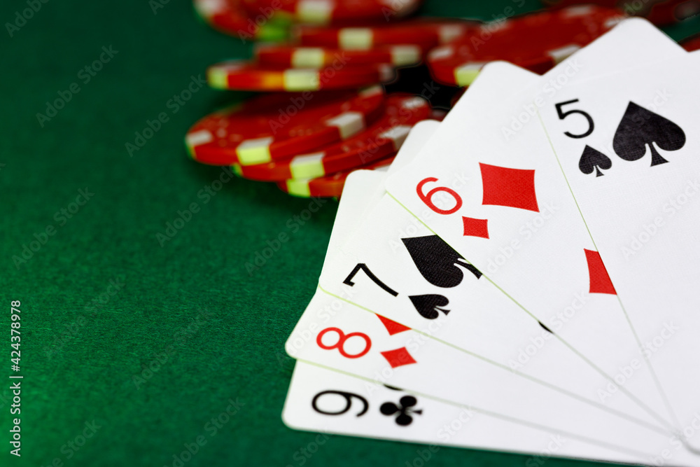Red playing chips and cards on poker table Red playing chips and cards on poker table
