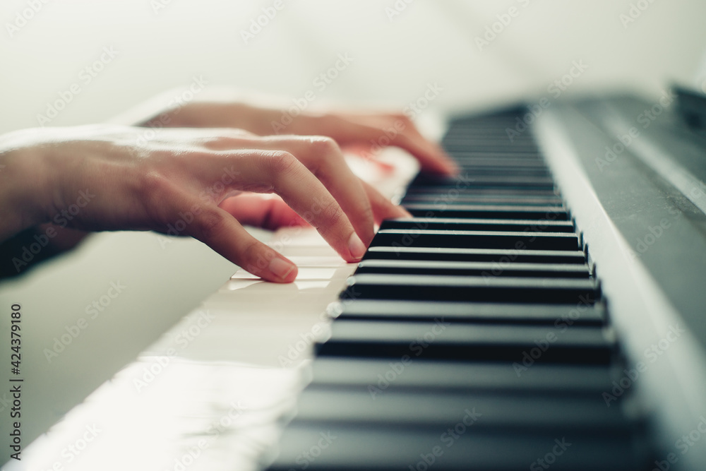 Fototapeta premium hands on the piano close-up