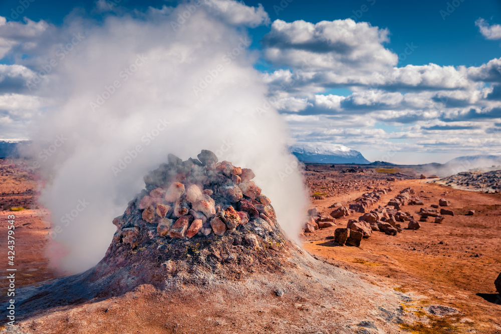 Steaming fumarole in geothermal valley Hverarond, Reykjahlid village location. Incredible summer view of Iceland, Europe. Beauty of nature concept background.