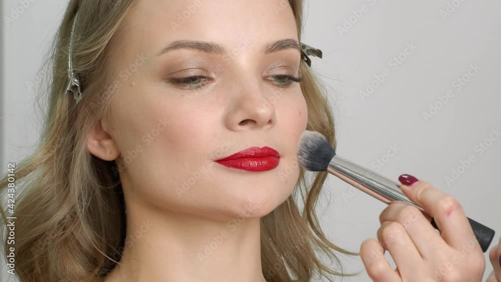 beautiful blonde in a beauty salon, does makeup beautiful blonde in a beauty salon, does makeup