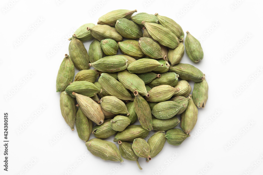 Fototapeta premium Macro close-up of Organic Cardamom or cardamum (Elettaria cardamomum) on white background. Pile of Indian Aromatic Spice. Top view