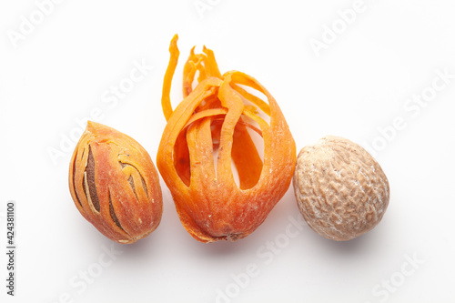 Macro close-up of Organic mace with nutmeg seed   (Myristica fragrans) on white background. Pile of Indian Aromatic Spice. Top view photo