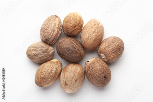 Macro close-up of Organic mace with nutmeg seed (Myristica fragrans) on white background. Pile of Indian Aromatic Spice. Top view