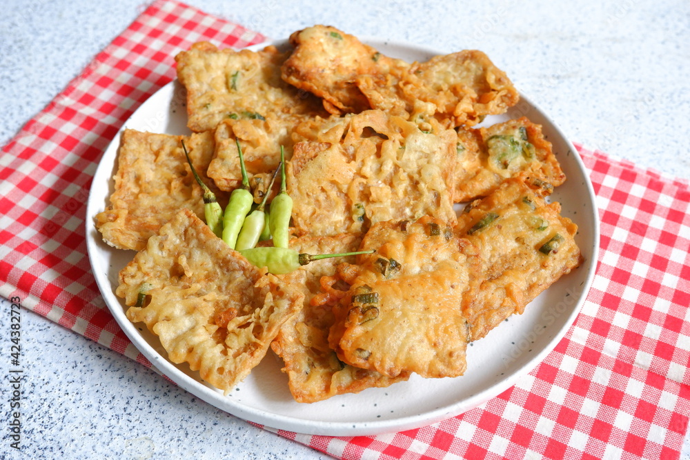 a plate of fried crispy tempeh served with fresh chili a plate of fried crispy tempeh served with fresh chili