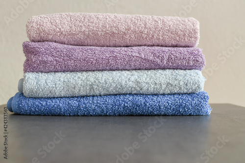 A stack of fresh towels on the bathroom table. Copy space