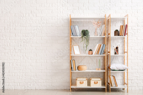 Modern shelf units near brick wall photo