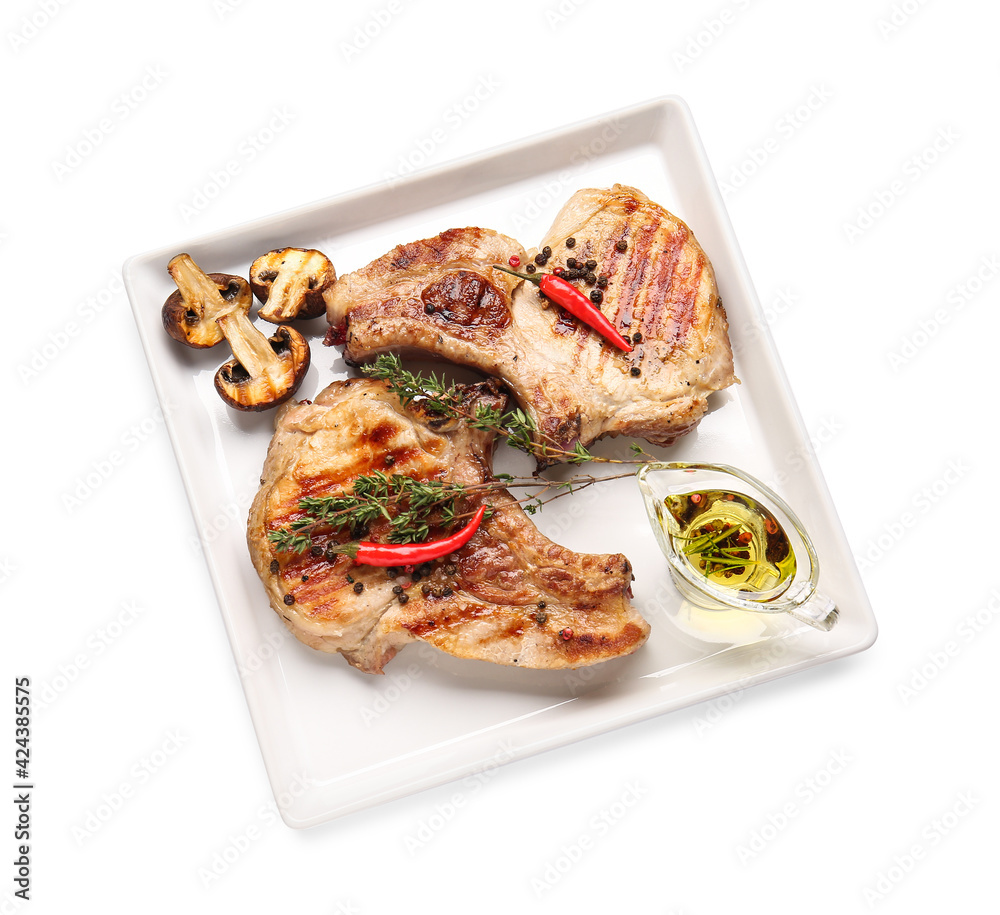 Plate with tasty steaks and spices on white background Plate with tasty steaks and spices on white background