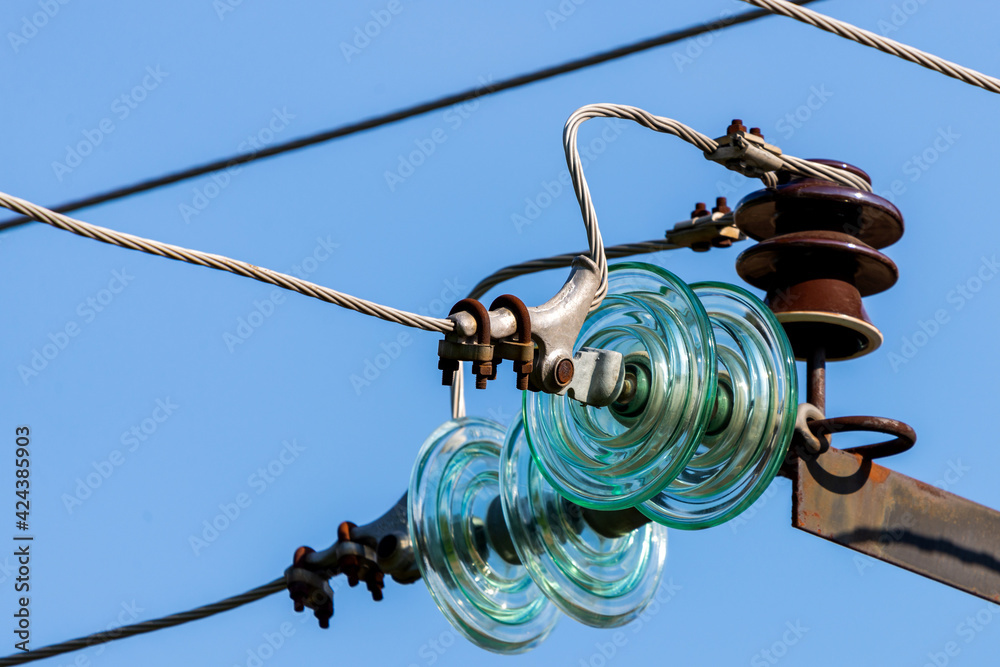 Electric pole against the blue clear sky. Three-phase power line to turn Electric pole against the blue clear sky. Three-phase power line to turn