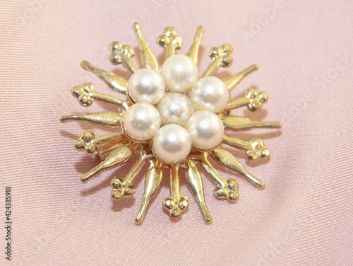 Beautiful women's vintage gold brooch, with bright natural pearls.