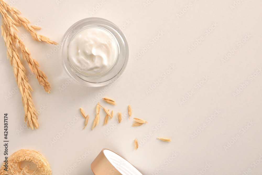 Background with oat moisturizer cream with spikes on white table