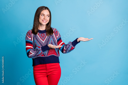 Photo of young attractive girl happy smile demonstarte hands product promo offer isolated over blue color background