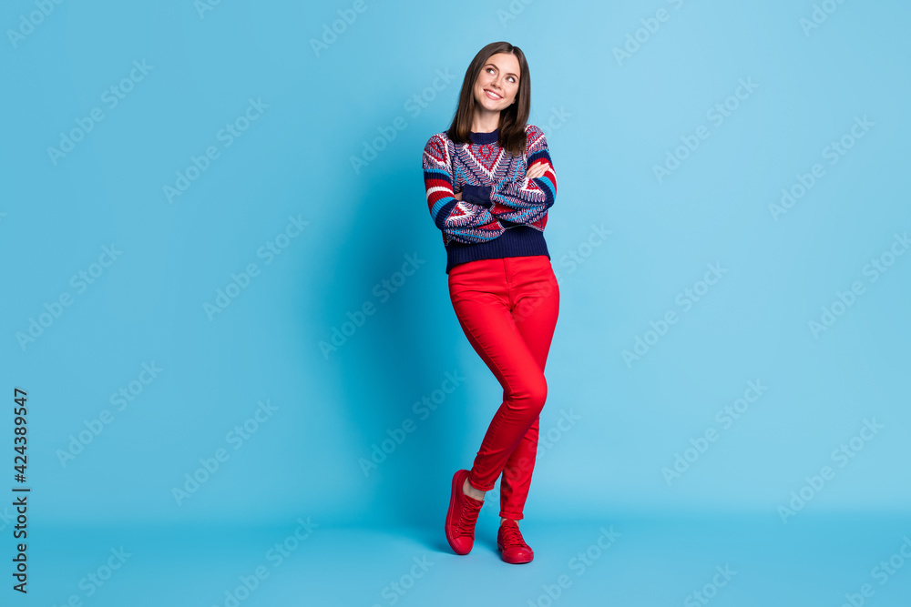 Full length body size photo of girl looking blank space with crossed hands isolated on bright blue color background