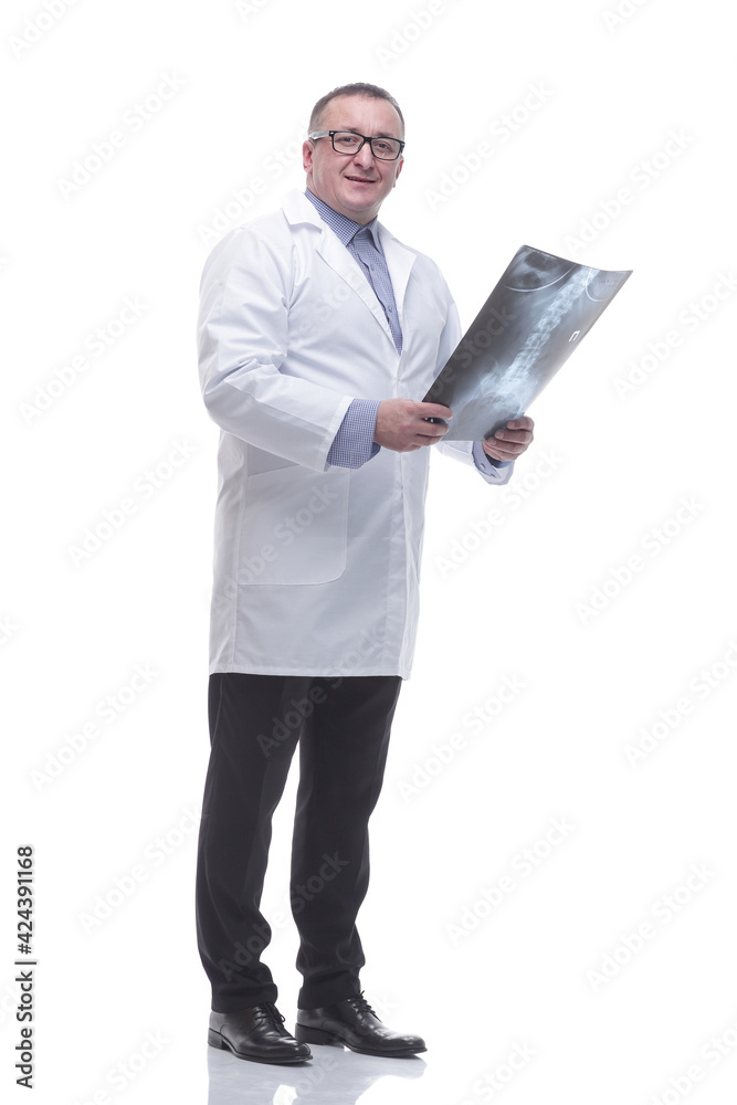 in full growth. smiling male doctor looking at an x- ray in full growth. smiling male doctor looking at an x- ray