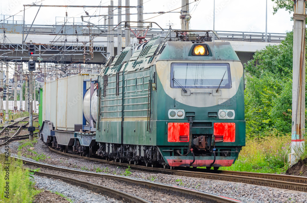 The freight train passes by the station. Wagons with goods delivery. The freight train passes by the station. Wagons with goods delivery.