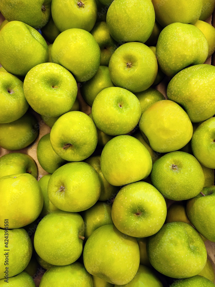 Shiny green apples for background, healthy food, fruits. Box of green apples. Green apples in a box Shiny green apples for background, healthy food, fruits. Box of green apples. Green apples in a box