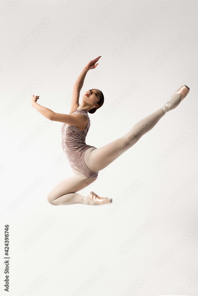 Ballerina jumping on white background