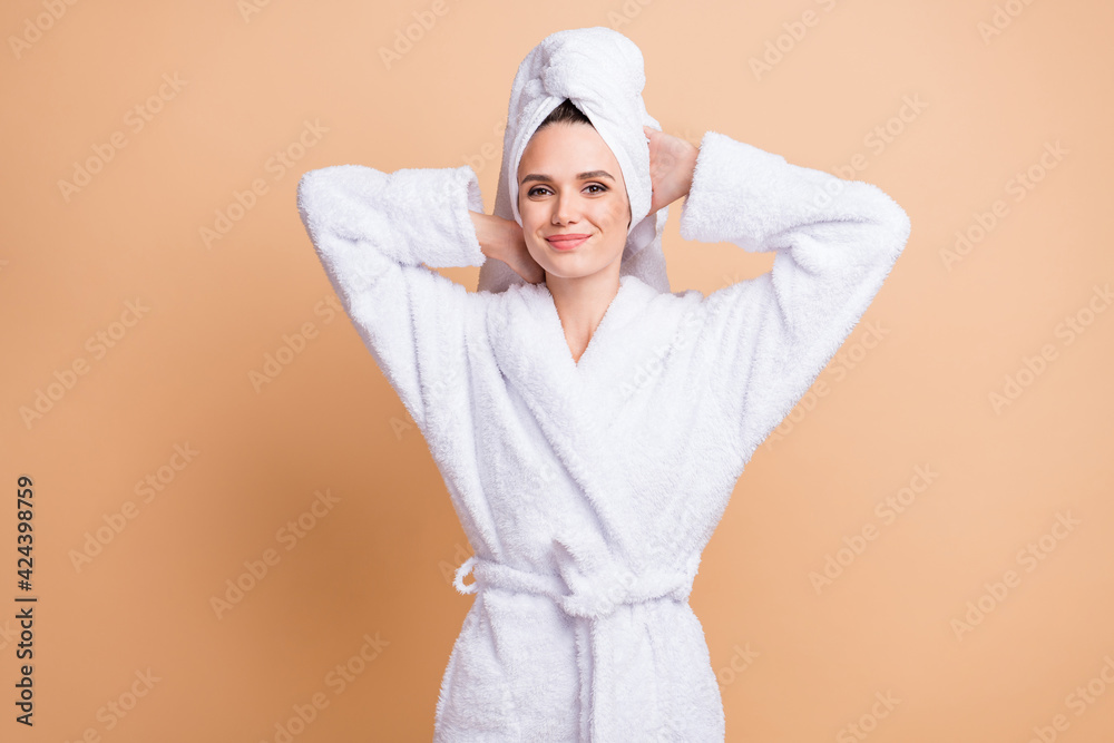Portrait of charming healthy cheery girl wearing bathrobe enjoying relax day isolated over beige pastel color background Portrait of charming healthy cheery girl wearing bathrobe enjoying relax day isolated over beige pastel color background