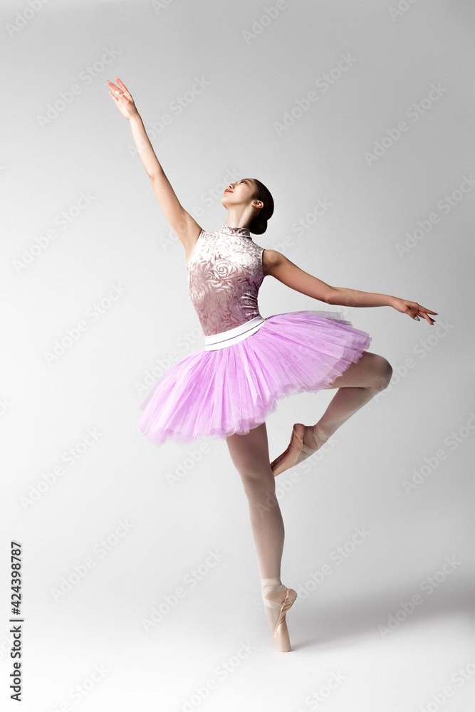 Naklejka premium Beautiful ballerina in pink tutu dancing