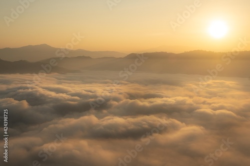 A sea of mist at the sunrise at the Iyaweng Betong Skywalk shining golden light. photo