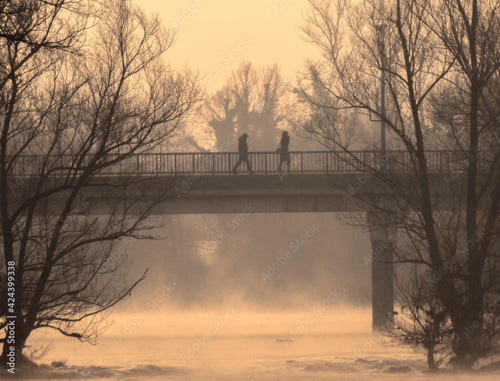 people on the bridge in fog