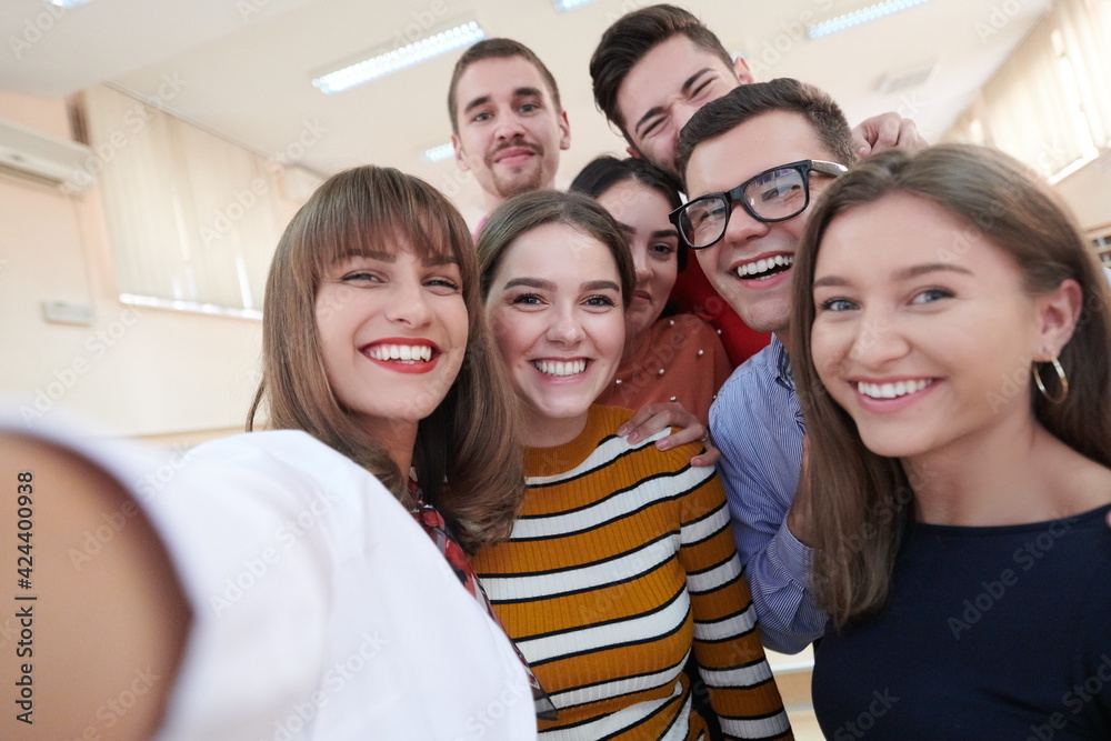 Group of multiethnic teenagers taking a selfie in school Group of multiethnic teenagers taking a selfie in school