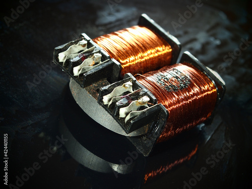 Obraz na płótnie Burnt power transformer with copper winding on black background.