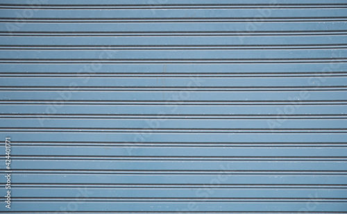 Straight lines or parallel lines of an iron door Rolling doors made of metal. Line pattern, rectangular shape from a rolling door Suitable for making banner, wallpaper or background.