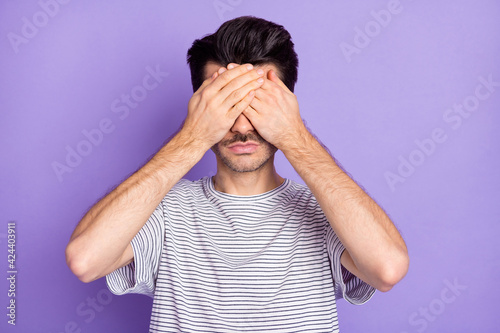 Portrait of attractive serious guy closing eyes cant see isolated over bright violet purple color background