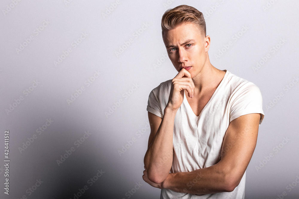 Fashion man model posing on grey background Fashion man model posing on grey background