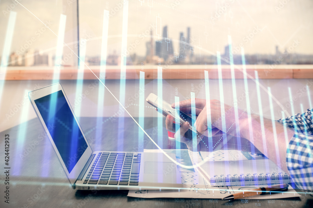 Double exposure of man's hands holding and using a digital device and forex graph drawing. Financial market concept. Double exposure of man's hands holding and using a digital device and forex graph drawing. Financial market concept.