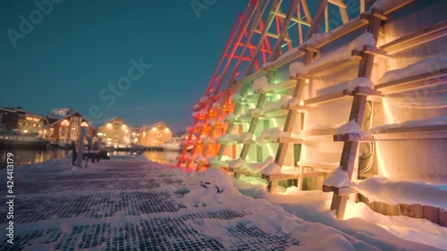 Modern Floating Sauna With Colorful Lights At Tromso Harbour In Norway During Winter. - Dolly Shot photo