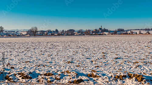 Beautiful winter landscape with the alps in the background on a sunny morning near Tittmoning, Bavaria, Germany