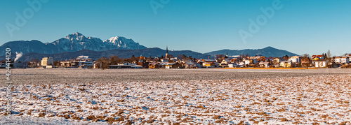 Beautiful winter landscape with the famous Hochstaufen summit in the background on a sunny morning near Freilassing, Bavaria, Germany photo