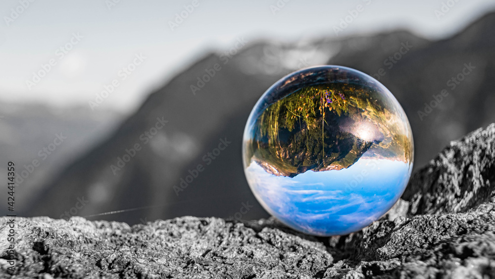 Crystal ball alpine landscape shot with black and white background outside the sphere at the famous Grossglockner High Alpine Road, Salzburg, Austria Crystal ball alpine landscape shot with black and white background outside the sphere at the famous Grossglockner High Alpine Road, Salzburg, Austria