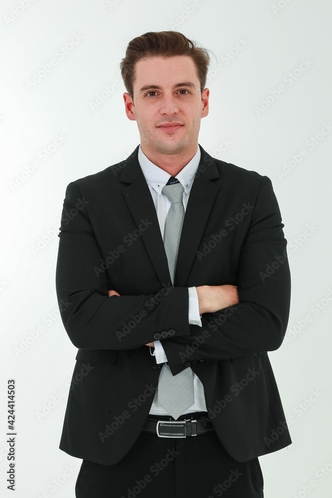 Portrait photo of young businessman in black suit studio shot isolated on white background looking straight at camera with confidence and positvie smile on happy face. Concept for modern man Portrait photo of young businessman in black suit studio shot isolated on white background looking straight at camera with confidence and positvie smile on happy face. Concept for modern man