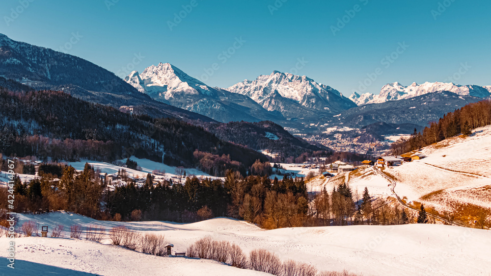 Beautiful winter landscape on a sunny morning with the famous Watzmann, Hochkalter and Reiteralm summits in the background at the Rossfeldstrasse near Berchtesgaden, Bavaria, Germany Beautiful winter landscape on a sunny morning with the famous Watzmann, Hochkalter and Reiteralm summits in the background at the Rossfeldstrasse near Berchtesgaden, Bavaria, Germany