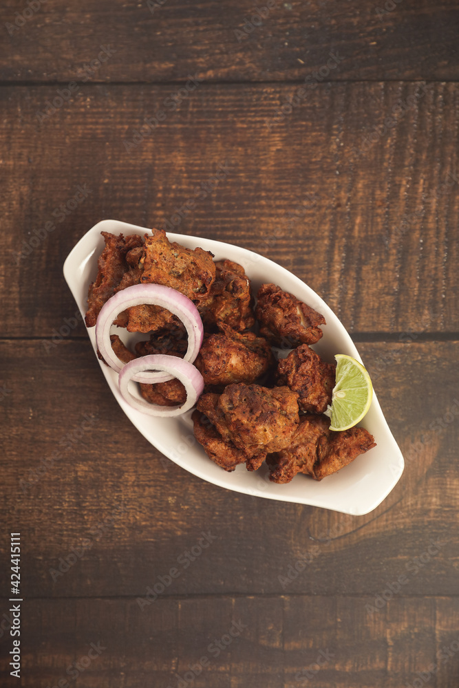 Delicious spicy Chicken Kabab Indian food on wooden table Delicious spicy Chicken Kabab Indian food on wooden table
