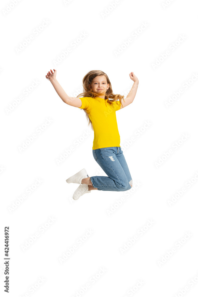 Happy kid, girl isolated on white studio background. Looks happy, cheerful, sincere. Copyspace. Childhood, education, emotions concept