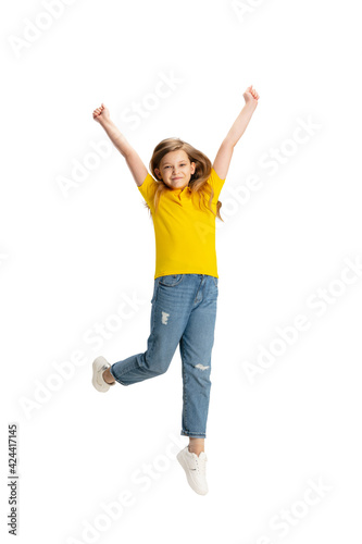 Happy kid, girl isolated on white studio background. Looks happy, cheerful, sincere. Copyspace. Childhood, education, emotions concept