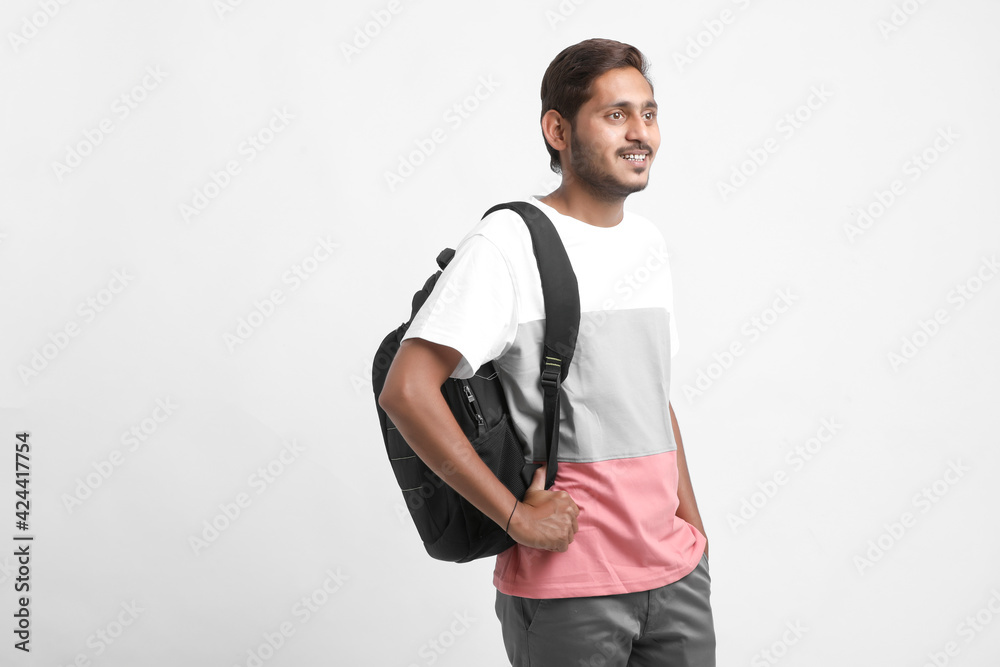 Handsome Indian college student carrying bag on white background. Handsome Indian college student carrying bag on white background.