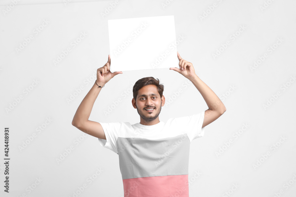 Indian male college student showing blank signboard Indian male college student showing blank signboard
