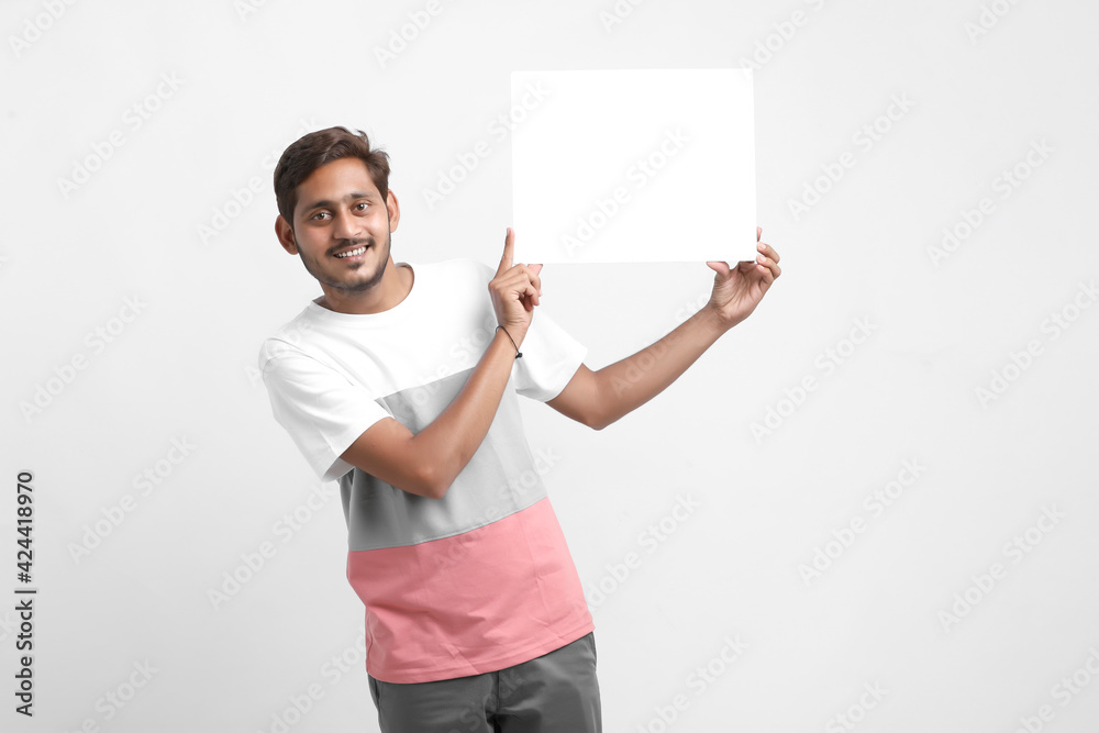 Indian male college student showing blank signboard Indian male college student showing blank signboard