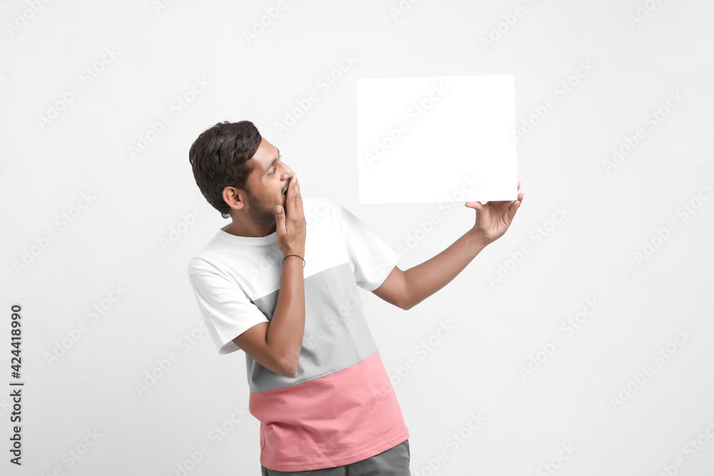 Indian male college student showing blank signboard Indian male college student showing blank signboard
