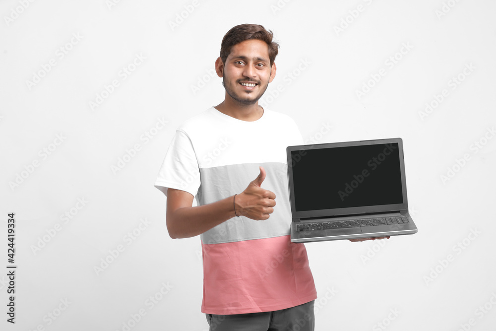 Indian college student showing laptop screen on white background. Indian college student showing laptop screen on white background.