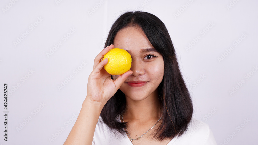 close up beautiful asian women with a lemon isolated on white background close up beautiful asian women with a lemon isolated on white background
