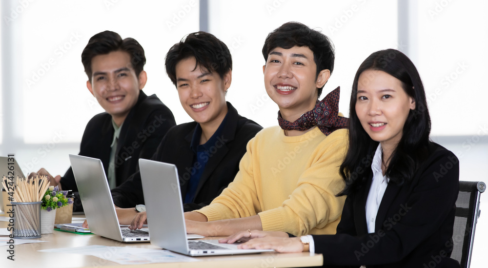 A group of multi-sex colleagues businesspeople, tomboy and transgender gay, working together with happy and intimate manner with laptop notebook computer in office A group of multi-sex colleagues businesspeople, tomboy and transgender gay, working together with happy and intimate manner with laptop notebook computer in office