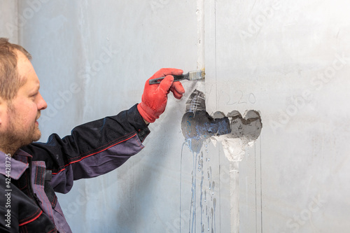 The electrician will prime the holes and channels for outlets and wires.